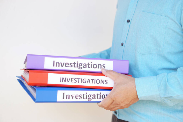 Close up a detective officer holds investigation folders. Concept, crime. Analyzing criminal investigation.      - Photo, Image