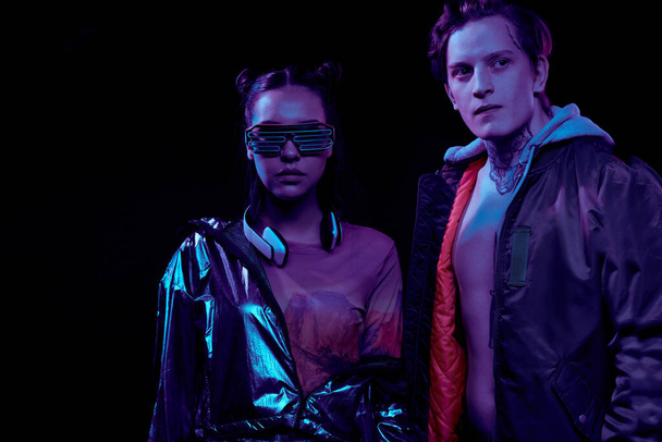 Cyber security agents in ultramodern outfits standing against black background - 写真・画像