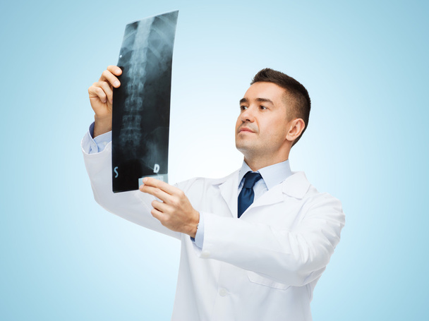 male doctor in white coat looking at x-ray - Fotó, kép