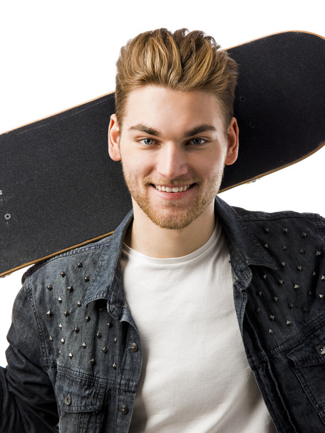 Young man with a skateboard - Fotó, kép