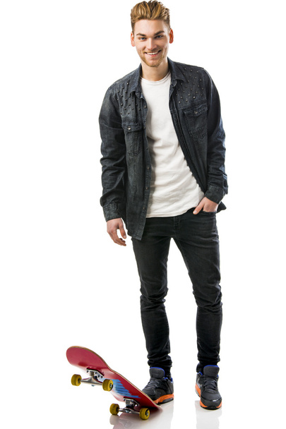 Young man with a skateboard - Φωτογραφία, εικόνα