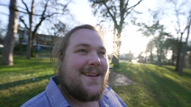 One young man enjoying nature outside during sunset time. Portrait of a happy male caucasian person feeling joy. Thoughtful pensive emotion - Footage, Video