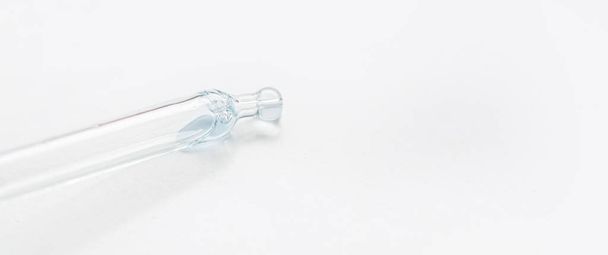 Cosmetic pipette with blue and blue gel, serum, serum on a light background. - Photo, Image