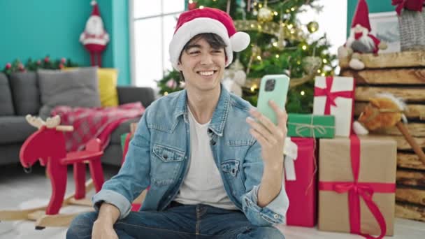Young hispanic man having video call holding new house key celebrating christmas at home - Footage, Video