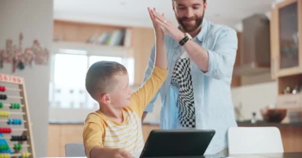 Tablet, education with a father and son high five during homework or to study while teaching in the kitchen. Tutor, school and motivation for a young boy student from a parent while distance learning. - Footage, Video
