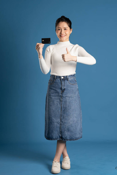 Image of beautiful Asian woman posing on blue background - Photo, Image