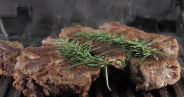 Delicious juicy beef steak with rosemary is cooked on an electric grill. Aged prime rare roast grilling tenderloin fresh marble tenderness beef. Prime beef fry on electric roaster. - Imágenes, Vídeo