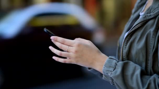 Woman, hands and phone in city for social media, communication or outdoor networking in road or street. Closeup of female person typing on mobile smartphone for online chatting or texting in town. - Footage, Video
