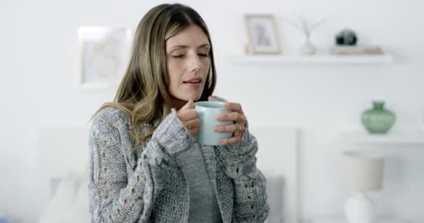 Woman, smell and coffee for aroma, scent or relaxing in morning with happiness in living room of home. Person, tea or smelling beverage with smile in lounge of house or apartment for break or peace. - Footage, Video