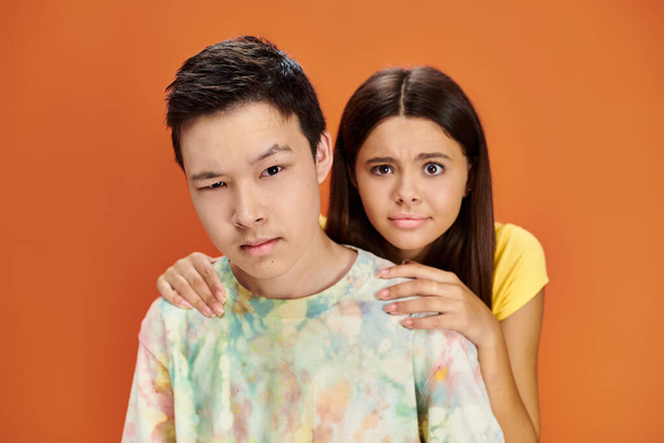 confused multiracial teens in vibrant clothes posing and looking at camera, friendship day - Photo, Image