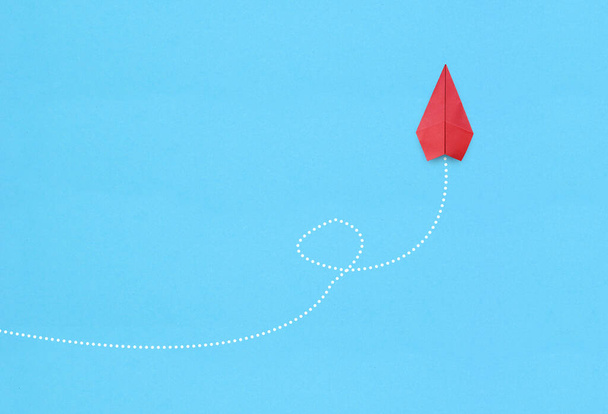 Red paper plane on blue background - Photo, Image
