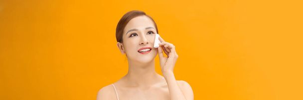 Woman Using Cotton Pad Cleansing Face Over banner yellow Background - Photo, Image