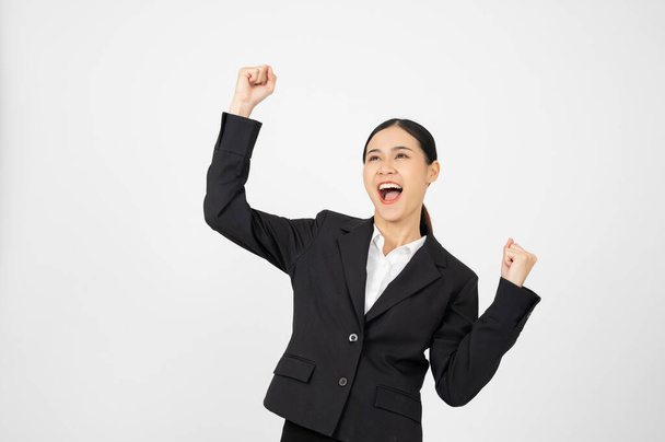 Happy businesswoman in black outfit with white isolated background. Celebrating pose. - Photo, Image