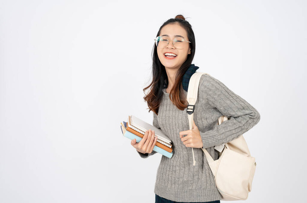 Šťastný rozkošný vysokoškolský student s knihami a batohem na bílém izolovaném pozadí. - Fotografie, Obrázek