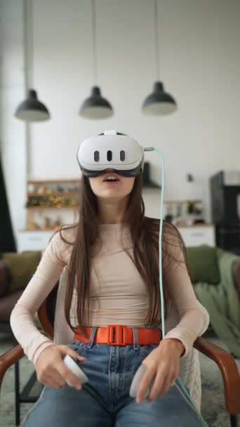 Inmitten von Neujahrsdekorationen bedient ein stilvolles Mädchen ein Virtual-Reality-Headset. Hochwertiges 4k Filmmaterial - Filmmaterial, Video
