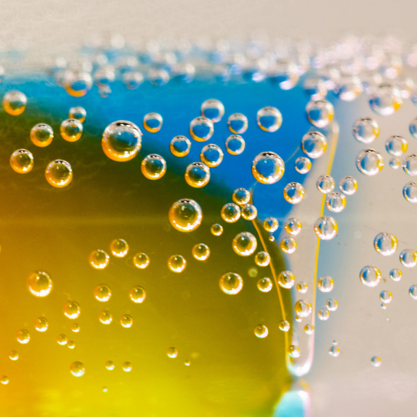 Composición abstracta con tubos subacuáticos con coloridas bolas de gelatina en el interior y burbujas
 - Foto, Imagen