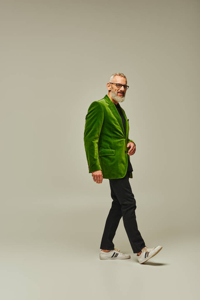 good looking jolly mature man in stylish vibrant clothes posing and smiling happily at camera - 写真・画像
