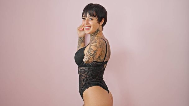 Hispanic woman with amputee arm wearing lingerie smiling over isolated pink background - Photo, Image