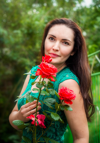 Portrait of a beautiful woman in a garden - Photo, Image