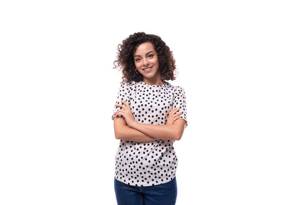 portrait of a slender curly young brunette dressed in a blouse on a white background with copy space. - Photo, Image