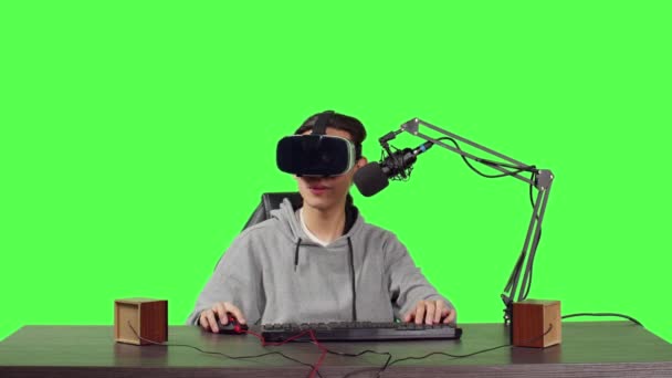 POV of streamer using virtual reality headset and transmitting live gameplay while sitting at desk, competing in online competition. Content creator video blogger records stream using vr. - Footage, Video