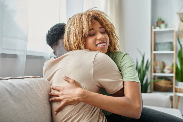 Ευγενική στιγμή μεταξύ του Αφροαμερικανού ζευγαριού στο σπίτι, δεσμός και εγγύτητα μεταξύ άνδρα και γυναίκας - Φωτογραφία, εικόνα