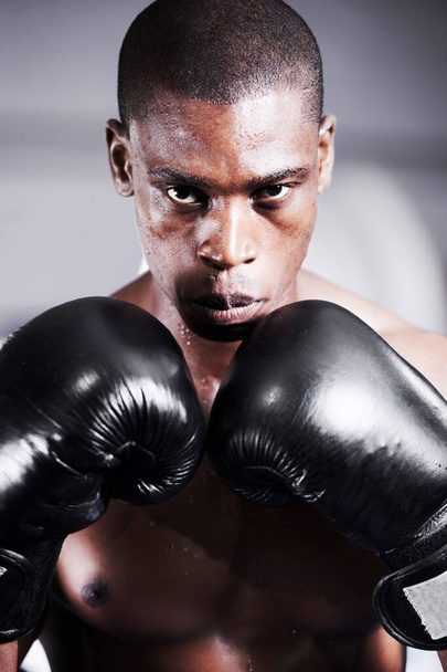 Boksen, handschoenen en portret van de zwarte man met zelfvertrouwen, fitness en workout uitdaging bij de sportclub. Sterk lichaam, gezicht van atleet of bokser in de sportschool met zweet en krijger macht in de strijd - Foto, afbeelding