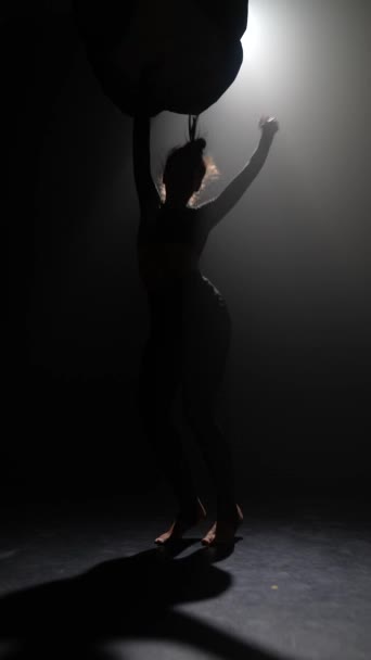 Em semi-gloom, uma jovem misteriosa está apresentando uma performance de dança moderna. Imagens 4k de alta qualidade - Filmagem, Vídeo