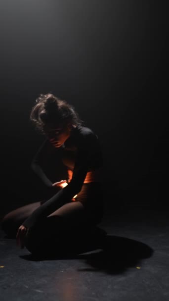 Eine hinreißende Frau zeigt die choreographischen Bewegungen des modernen Tanzes, während sie Licht hält. Hochwertiges 4k Filmmaterial - Filmmaterial, Video