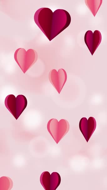 El fondo vertical animado presenta corazones de papel rojo y rosa volando sobre un fondo rosa pastel. Gráficos de movimiento en el concepto del Día de San Valentín. El video vertical animado en bucle. - Imágenes, Vídeo