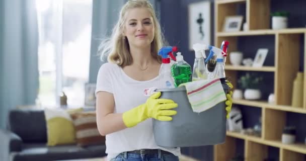 Woman, dancing and happy with cleaning living room for housework, detergents and pride in home. Young person, smile face and sanitizer or liquid disinfectant in lounge, gloves and chores in apartment. - Footage, Video
