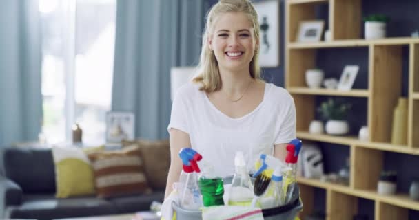 Woman, face and happy with cleaning detergent for housework, living room and pride in home. Young person, smile portrait and sanitizer or liquid disinfectant in lounge, gloves and chores in apartment. - Footage, Video