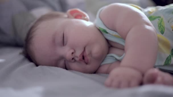 baby sleeping peacefully with selective focus on hand - Footage, Video