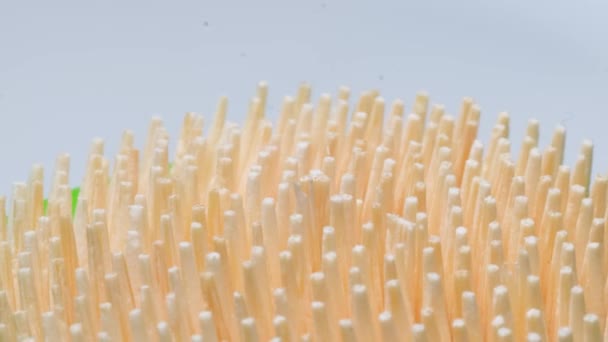 Macro video of a toothpick on a white background. Wooden sticks for cleaning teeth. - Footage, Video