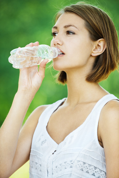 Young woman drinking water bottle - Photo, Image