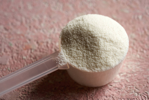 Collagen powder in a plastic measuring spoon - Photo, Image