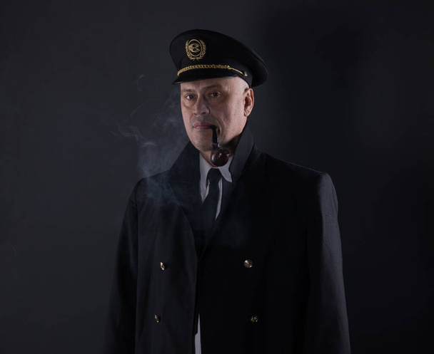 portrait captain of the ship on a black background - Photo, Image