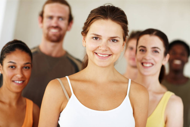 Portrait, smile or fitness and woman with a group of people in a studio for health, wellness or mindfulness. Exercise, training and pilates with happy young friends together in gym class for workout. - Photo, Image