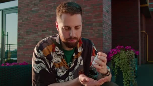 un hombre toma una píldora para la alergia de un envase y traga antes de comer alimentos con alérgenos saludables - Metraje, vídeo