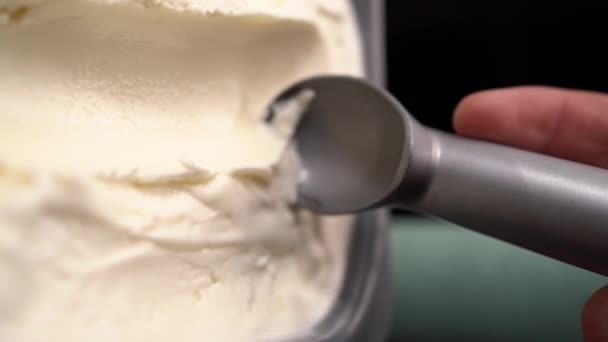 Metal scoop take out vanilla ice cream from container, Flat lay. Making ball of ice cream. Copy space - Footage, Video