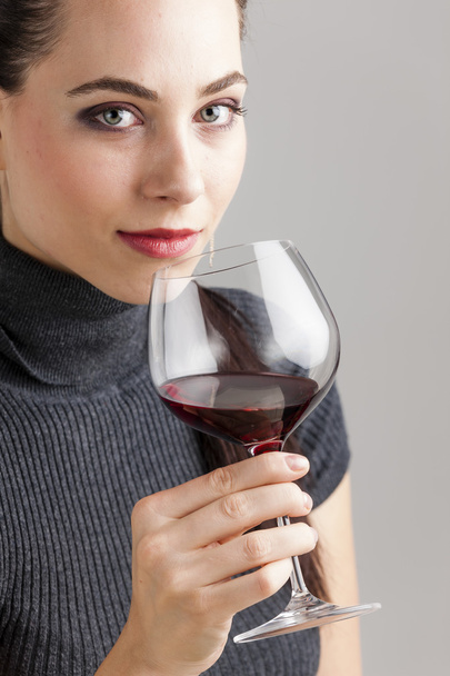 portrait of young woman with a glass of red wine - 写真・画像