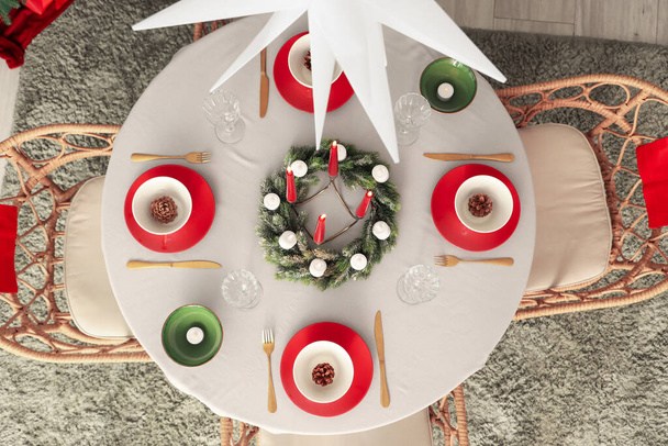 Festive table setting with burning candles and Christmas decorations, top view - Photo, Image