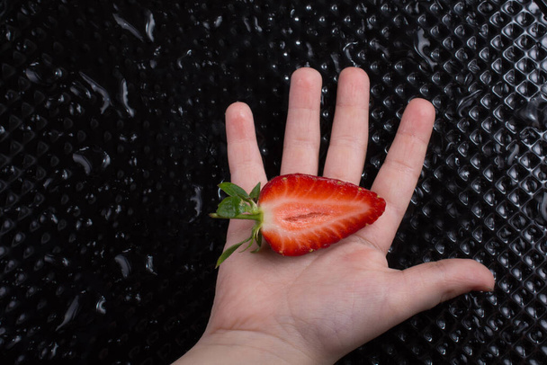 Juicy, sweet and ripe strawberry fruit in hand - Photo, Image