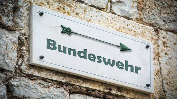 The picture shows a signpost and a sign that points in the direction of the Bundeswehr in German. - Photo, Image