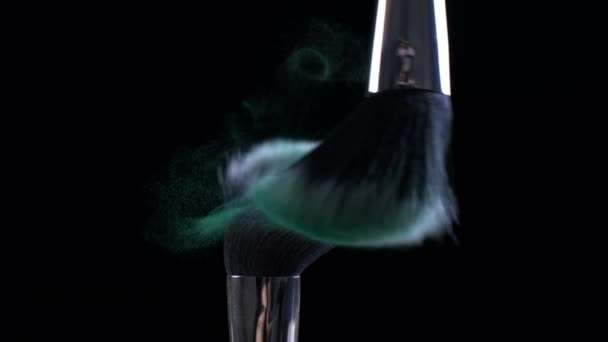 Кисти макияжа Коснувшись зеленых косметических частиц в Super Slow Motion на темном фоне, макро подробности крупным планом - Кадры, видео