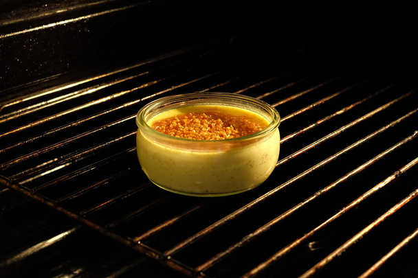 Creme brulee in the oven - Photo, Image