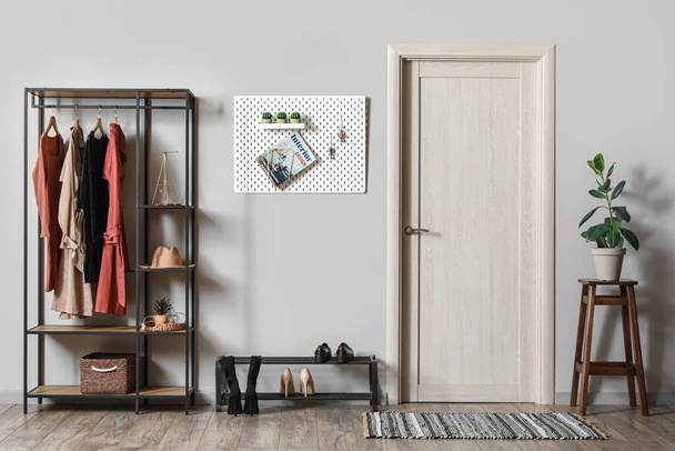 Interior of hall with pegboard, clothes rack and shoe stand - Photo, Image