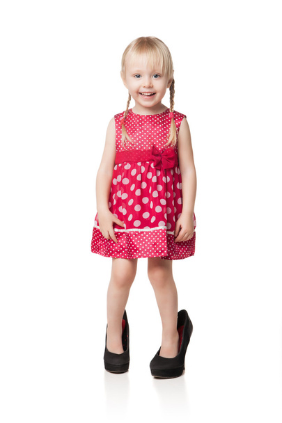 Smiling little girl wearing big shoes - Foto, Imagem