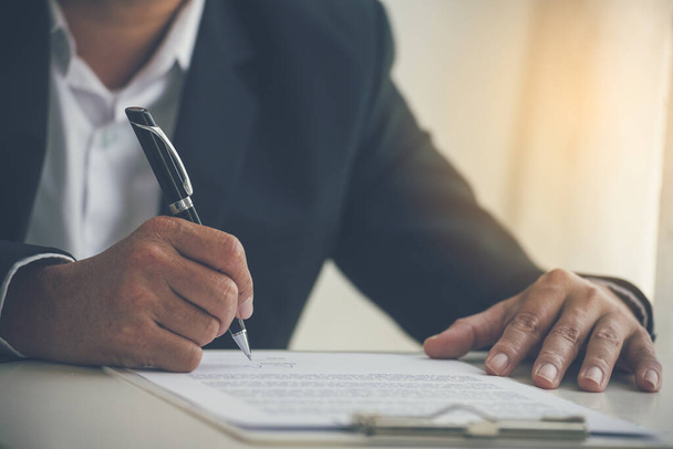 Asian business man using pen signing on new contract to starting projects in conference room. Close up manager businessman hands sign contract working meeting. Business agreement concepts. - Fotoğraf, Görsel