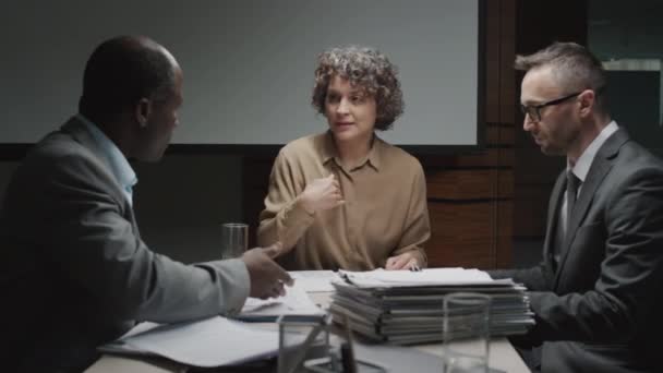 Medium shot of female Caucasian executive tearing document rejecting to work with diverse male business partners during office meeting - Footage, Video